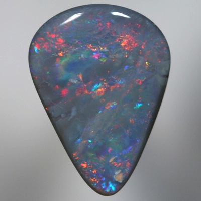 SOLID SEMI BLACK OPAL Sparkles of fire red and orange over blue green